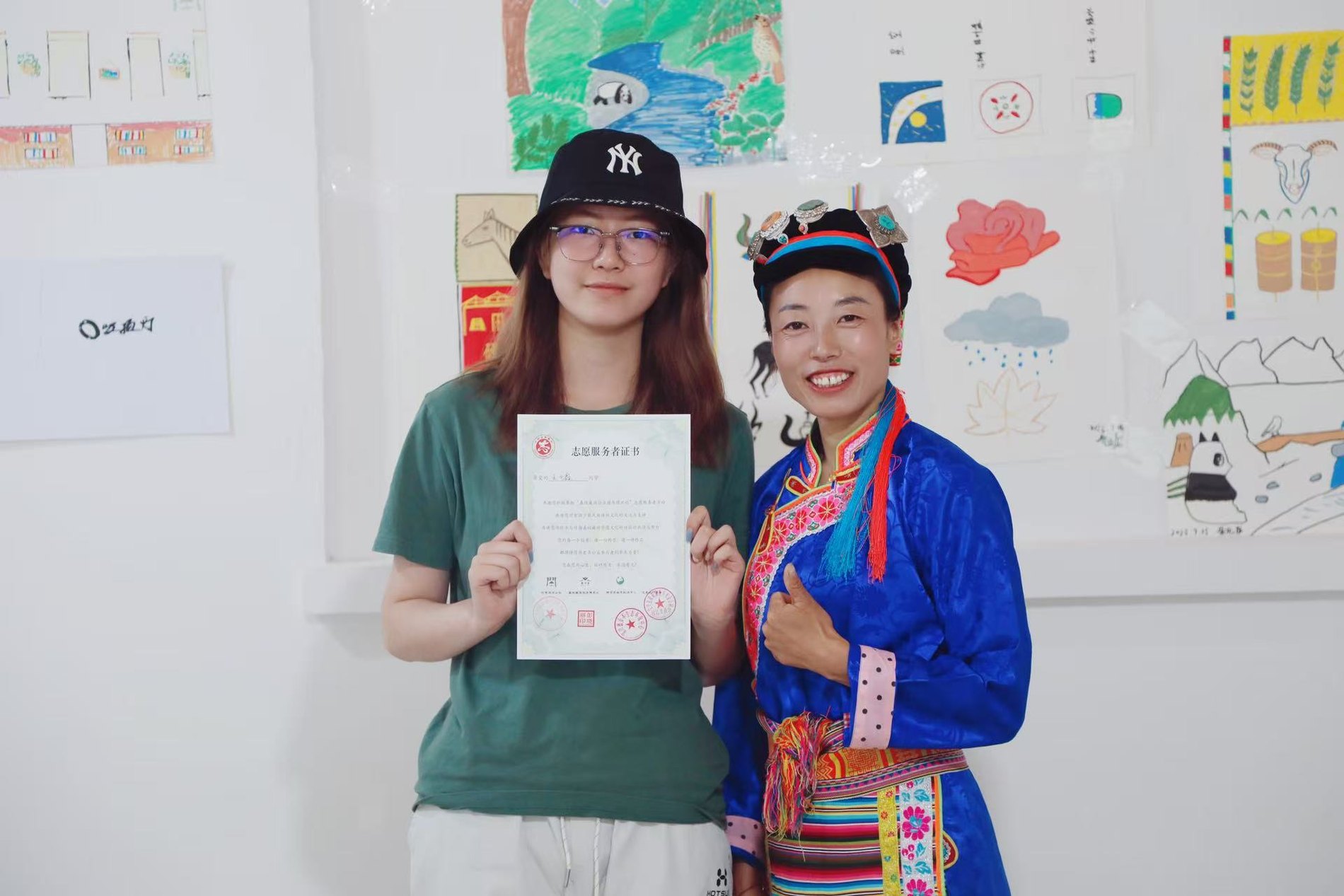 Two people holding materials at an event